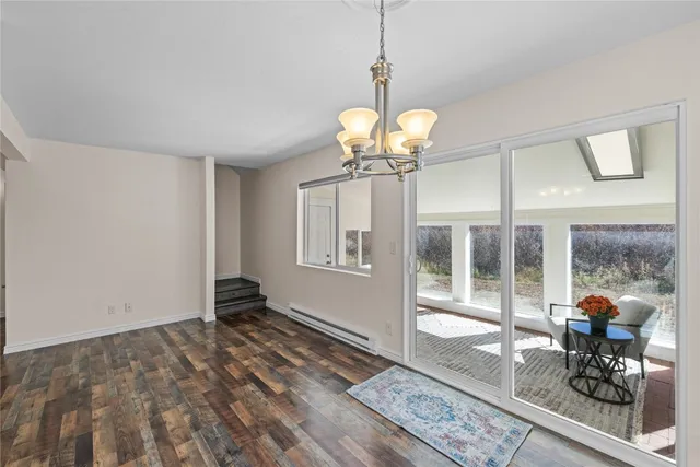 a view of a room with wooden floor and windows