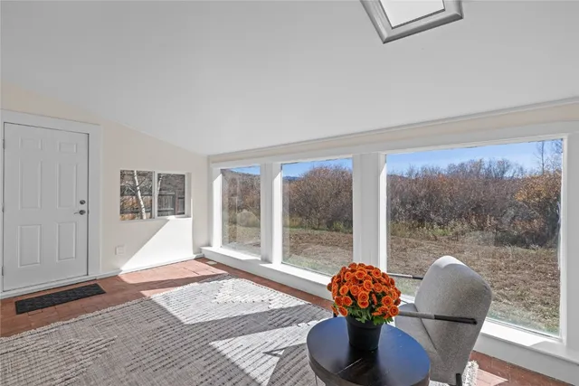 a living room filled with furniture and a large window