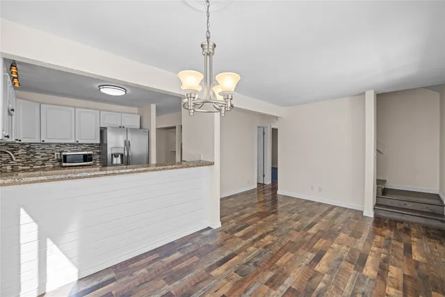 a view of a kitchen with microwave and cabinets