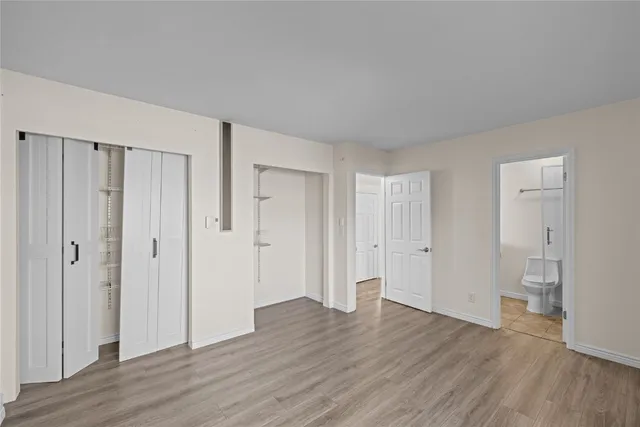 a view of an empty room and wooden floor