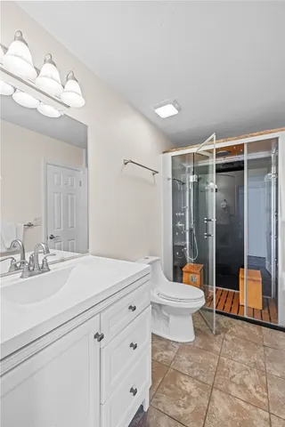 a bathroom with a sink mirror and shower