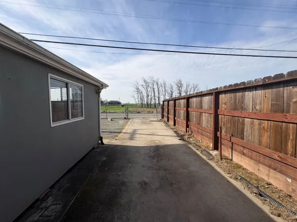 a view of a porch with wooden floor and fence
