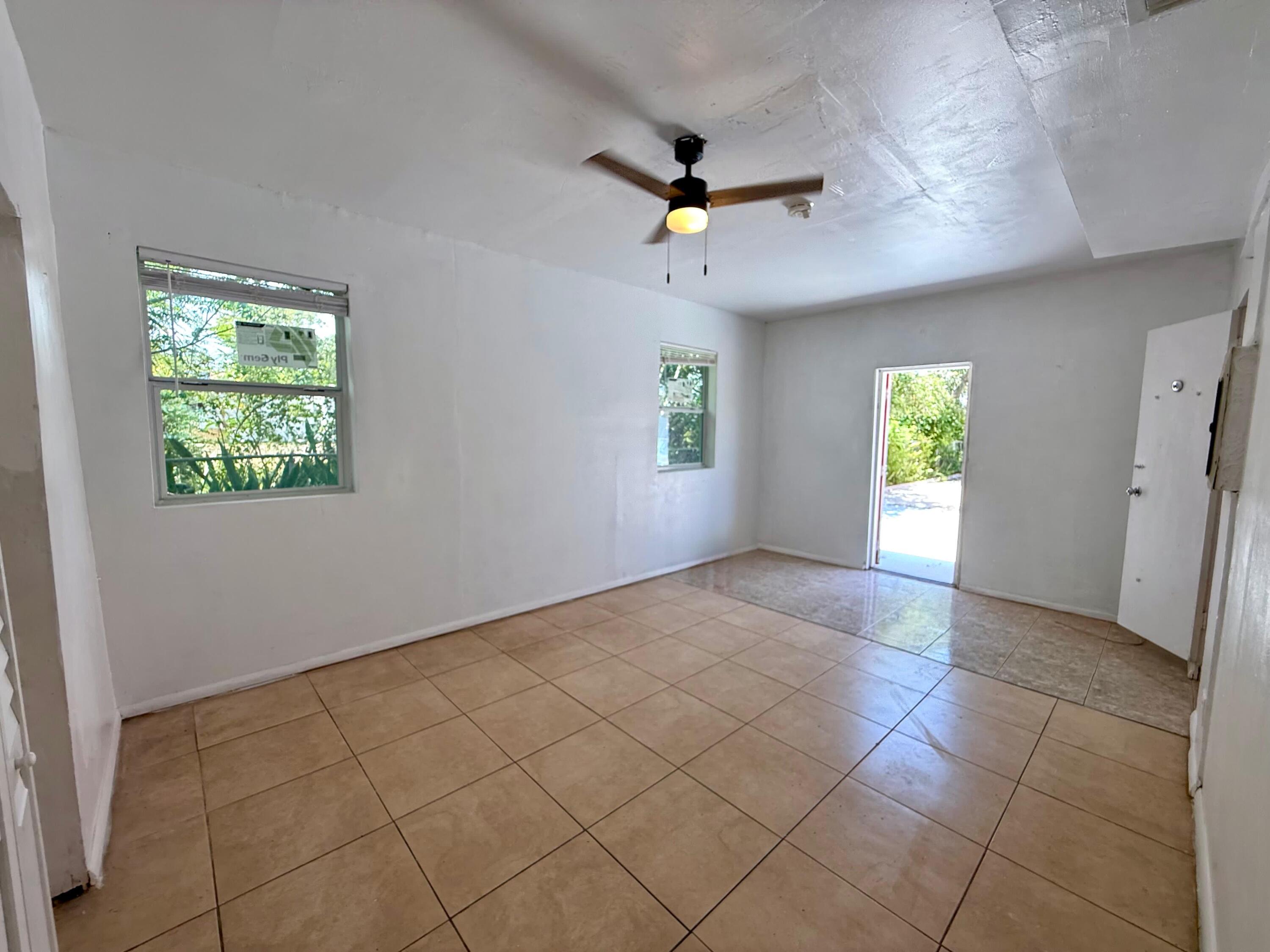 926 33rd Street, Unit BACK West Palm Beach, FL 33407 - Photo 3 of 7 a view of an empty room with window and chandelier fan