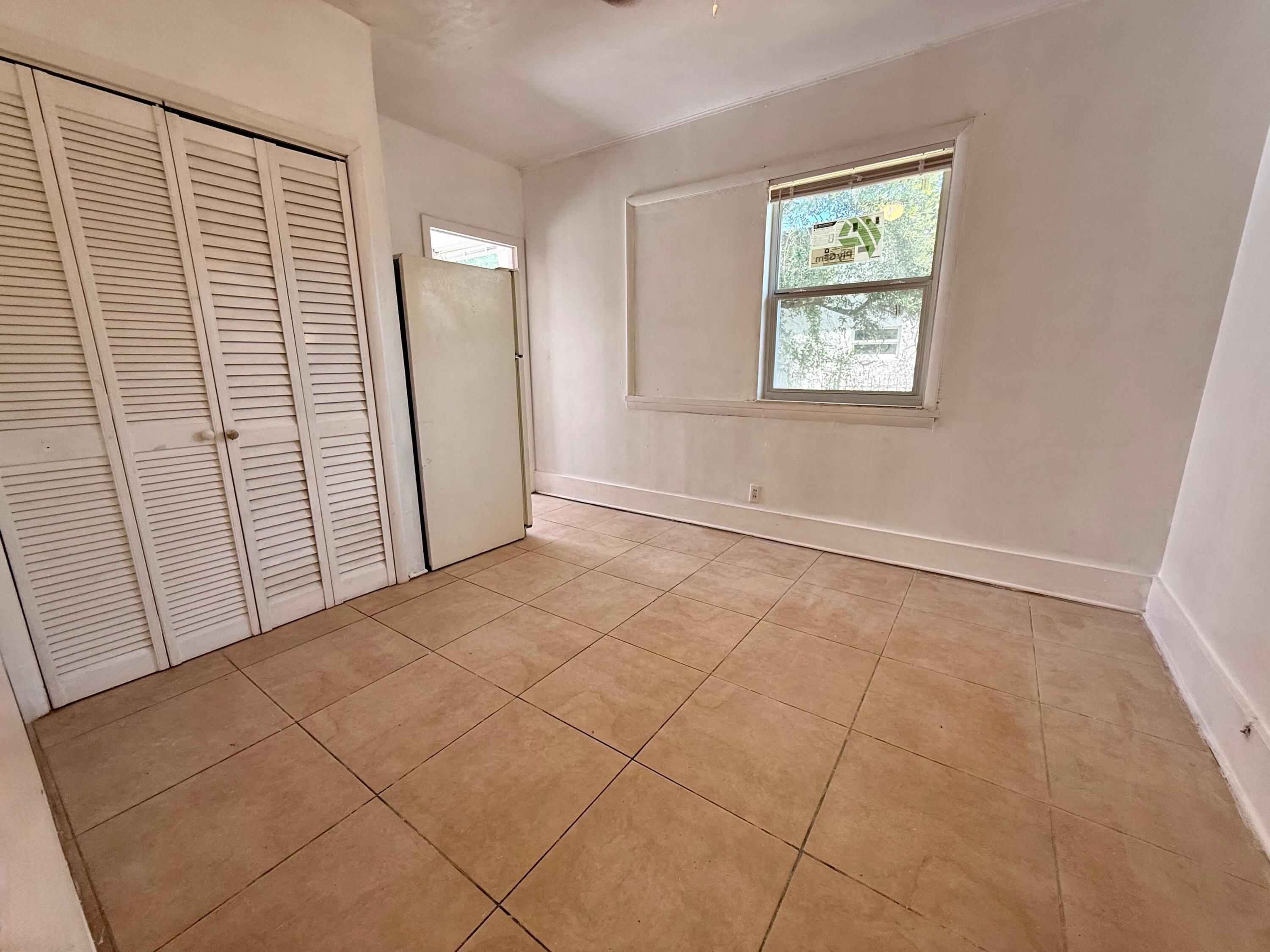926 33rd Street, Unit BACK West Palm Beach, FL 33407 - Photo 4 of 7 a view of an empty room with a window