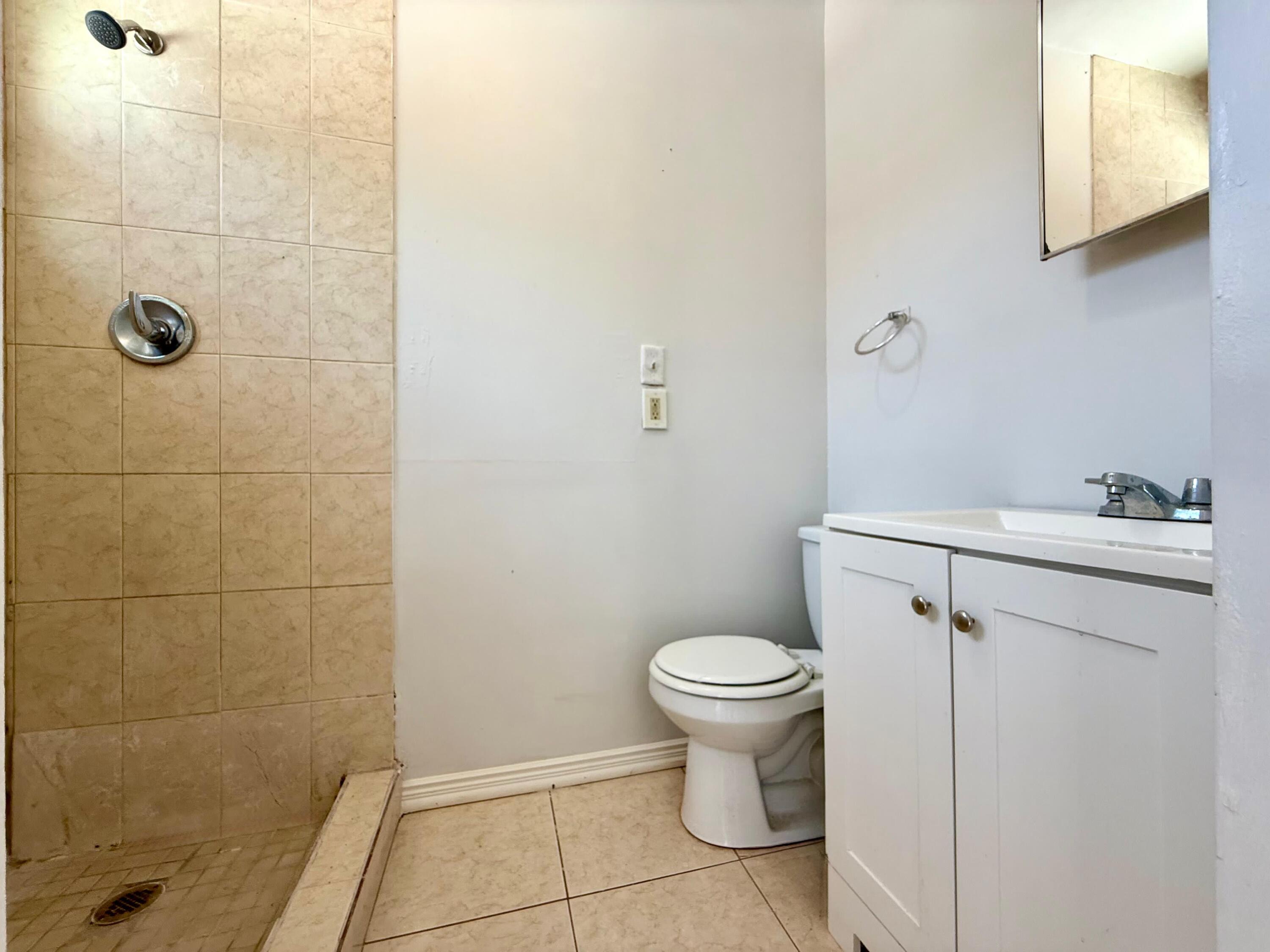 926 33rd Street, Unit BACK West Palm Beach, FL 33407 - Photo 5 of 7 a bathroom with a sink a toilet and shower
