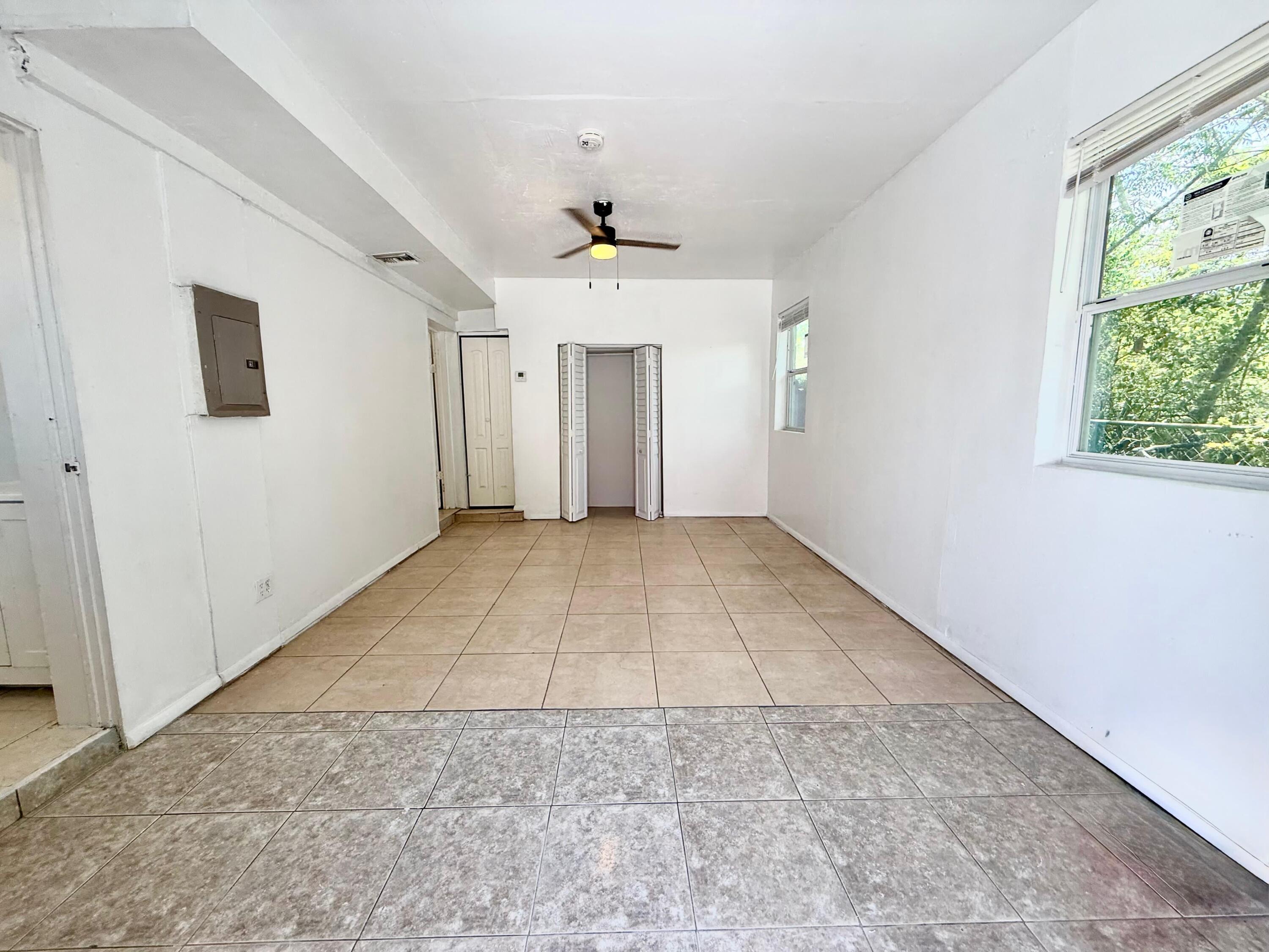 926 33rd Street, Unit BACK West Palm Beach, FL 33407 - Photo 6 of 7 an empty room with a window and a ceiling fan