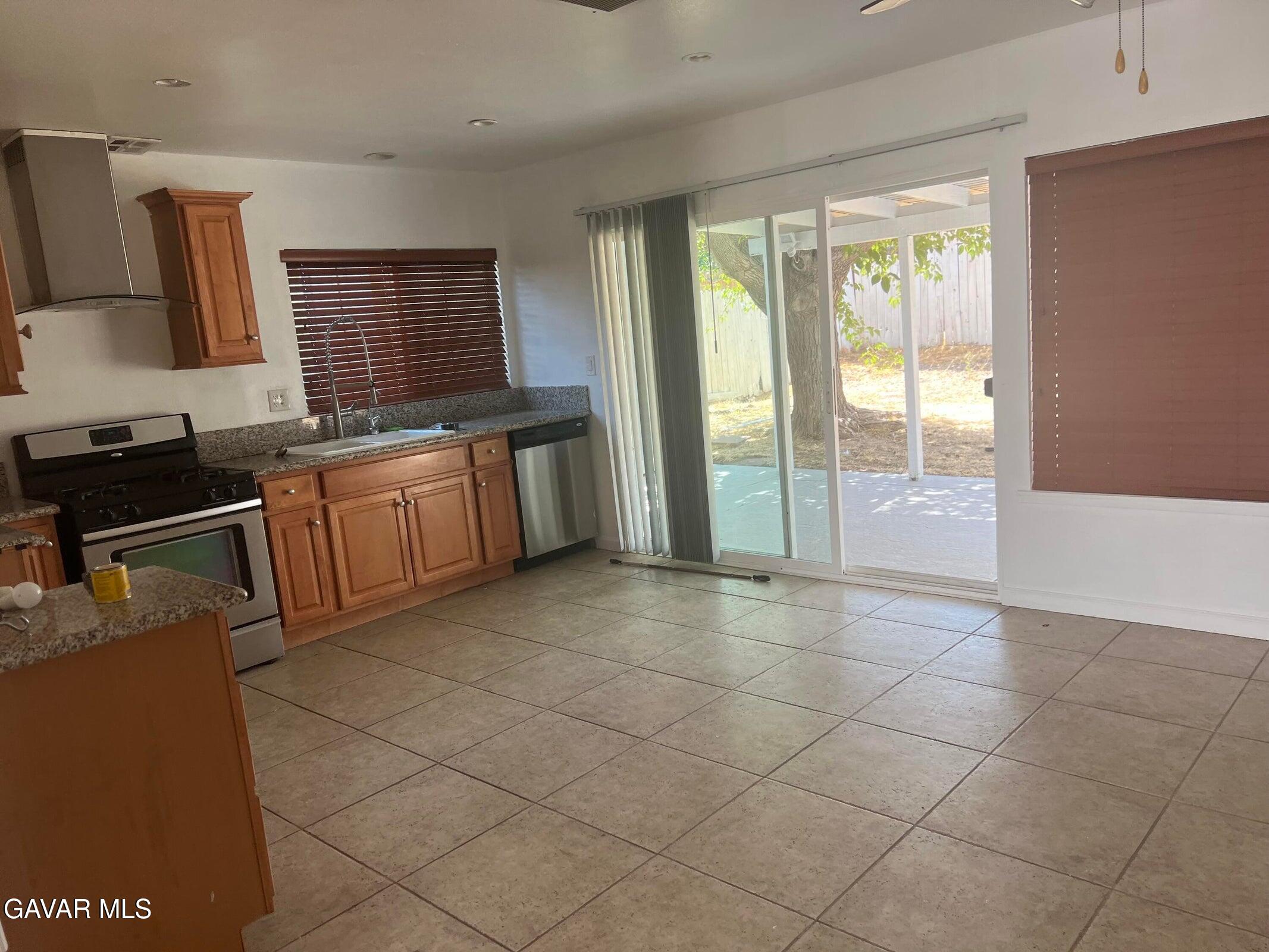 42901 Alep Street Lancaster, CA 93536 - Photo 4 of 11 a spacious bathroom with a granite countertop sink a mirror and a bathtub