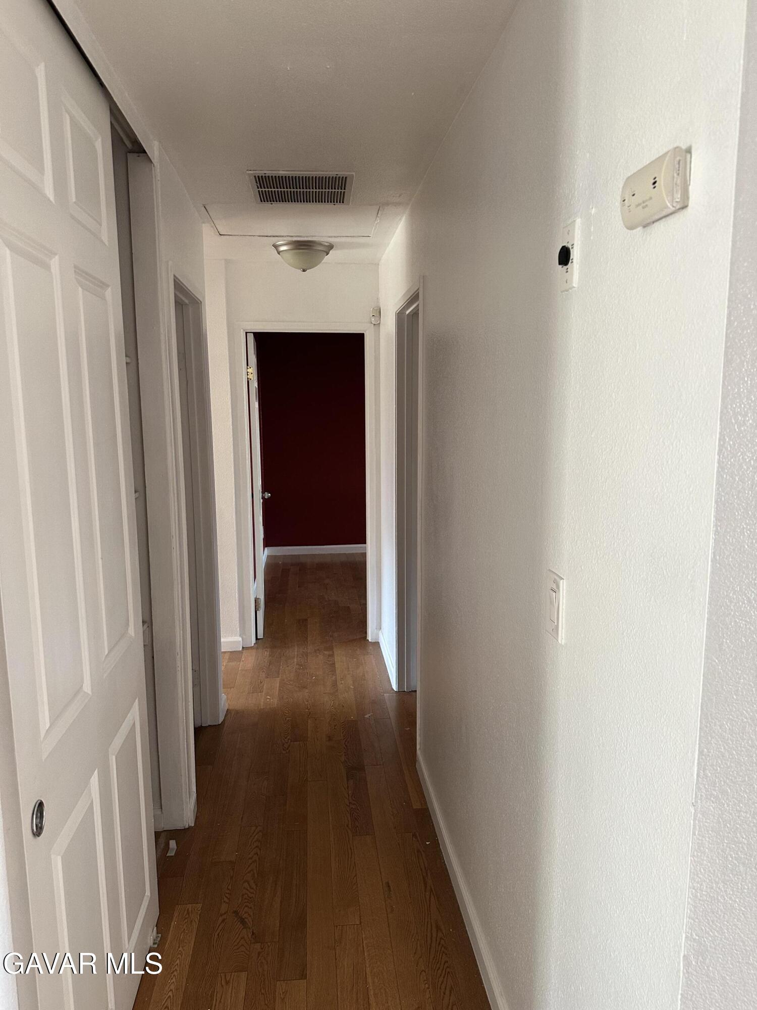 42901 Alep Street Lancaster, CA 93536 - Photo 7 of 11 a view of a hallway with wooden floor