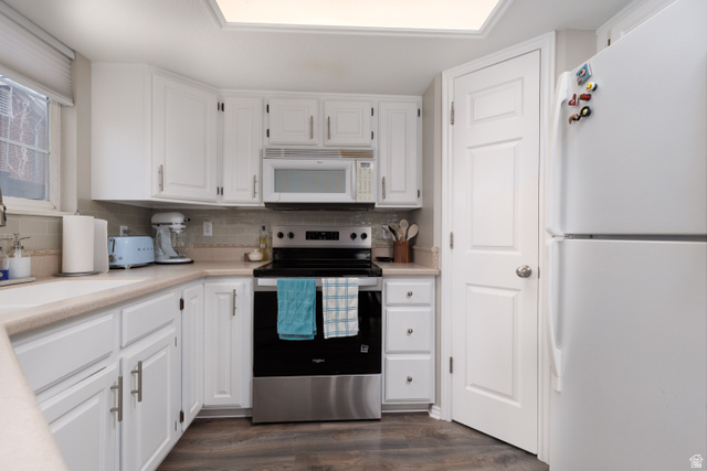 260 400 North, Unit 1 Orem, UT 84057 - Photo 5 of 17 Kitchen with white appliances, white cabinets, light countertops, and dark wood finished floors