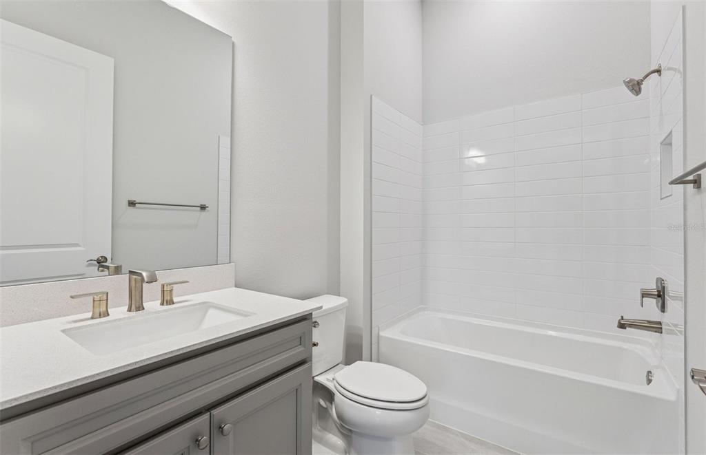 5230 Southwest 88th Circle Ocala, FL 34481 - Photo 13 of 35 a bathroom with a sink a toilet and a bathtub