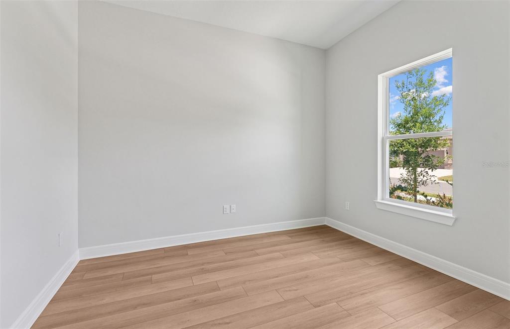 5230 Southwest 88th Circle Ocala, FL 34481 - Photo 14 of 35 an empty room with wooden floor and windows