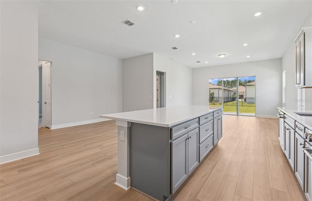 5230 Southwest 88th Circle Ocala, FL 34481 - Photo 6 of 35 a kitchen with stainless steel appliances a sink and wooden floor