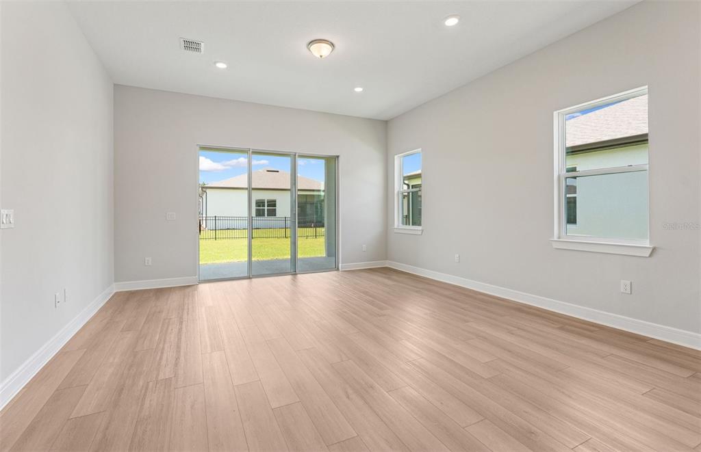 5230 Southwest 88th Circle Ocala, FL 34481 - Photo 7 of 35 an empty room with a window and wooden floor