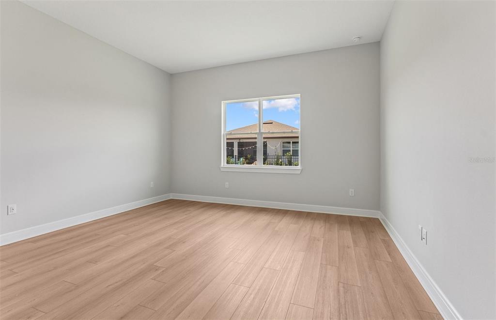 5230 Southwest 88th Circle Ocala, FL 34481 - Photo 9 of 35 an empty room with wooden floor and windows