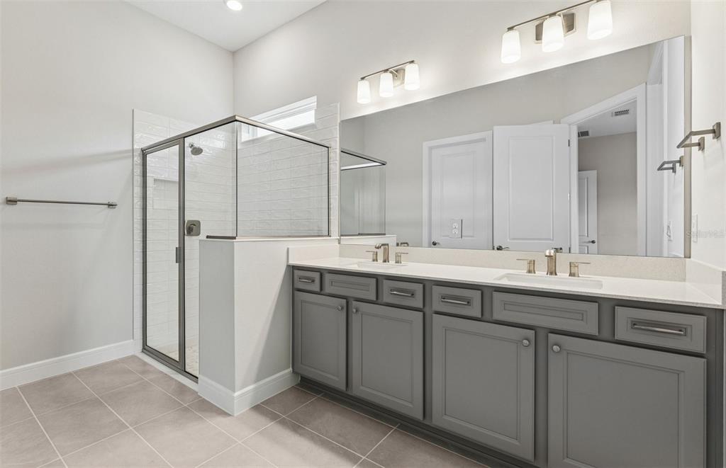 5230 Southwest 88th Circle Ocala, FL 34481 - Photo 10 of 35 a bathroom with a double vanity sink and mirror