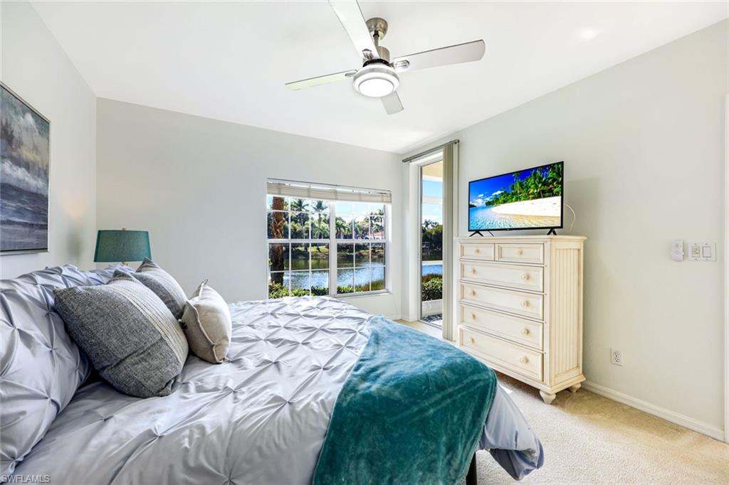 10921 Santa Margherita Road, Unit 103 Estero, FL 34135 - Photo 12 of 38 a bedroom with a bed dresser and a window