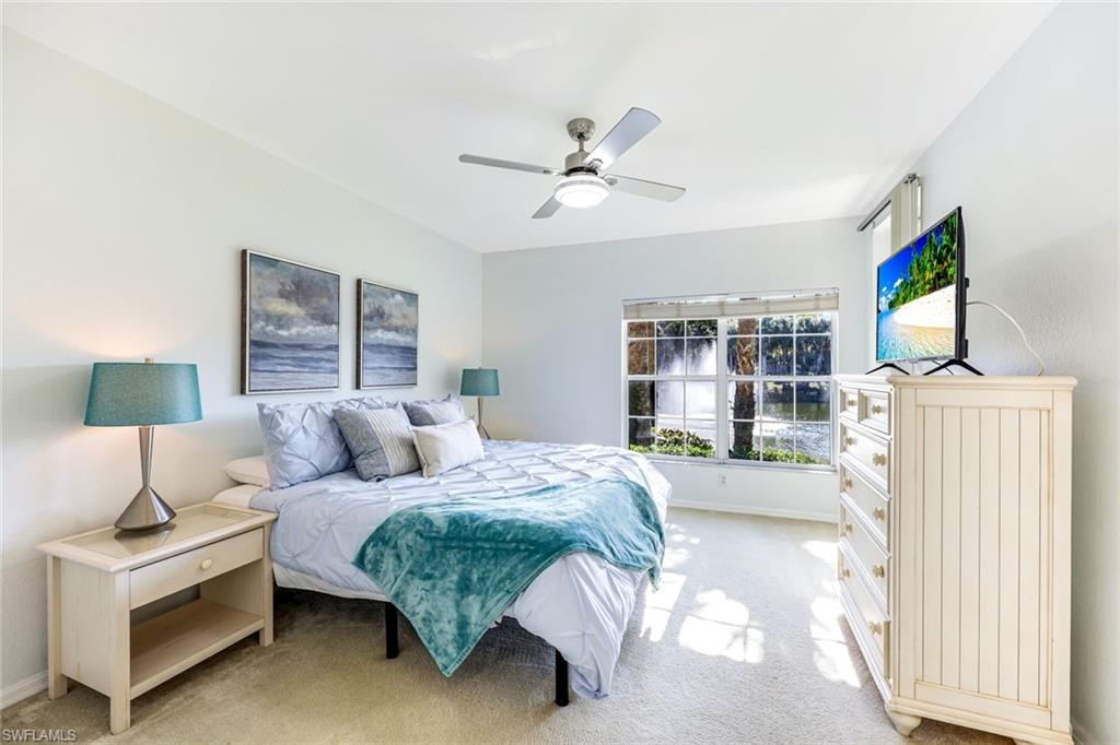 10921 Santa Margherita Road, Unit 103 Estero, FL 34135 - Photo 38 of 38 a bedroom with a bed wooden floor and window