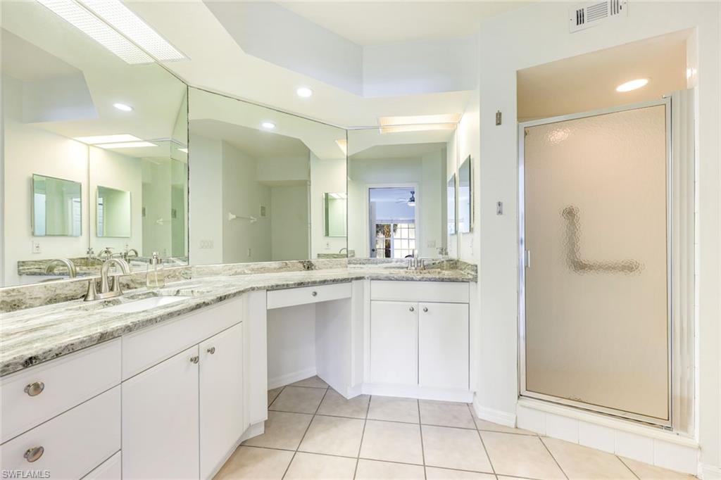 10921 Santa Margherita Road, Unit 103 Estero, FL 34135 - Photo 13 of 38 a bathroom with a sink and a mirror