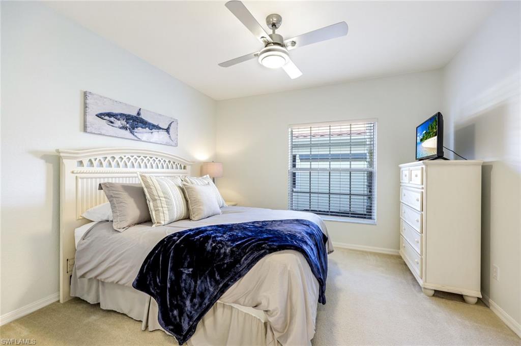 10921 Santa Margherita Road, Unit 103 Estero, FL 34135 - Photo 14 of 38 a bedroom with a bed and a window
