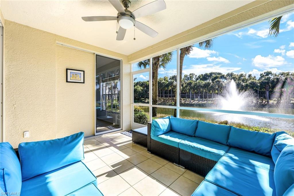 10921 Santa Margherita Road, Unit 103 Estero, FL 34135 - Photo 17 of 38 a living room with couch and a floor to ceiling window