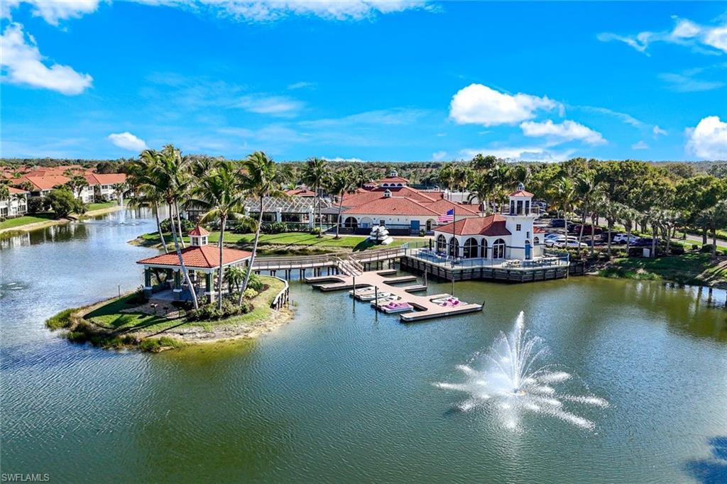 10921 Santa Margherita Road, Unit 103 Estero, FL 34135 - Photo 20 of 38 a view of a lake with boats and trees all around