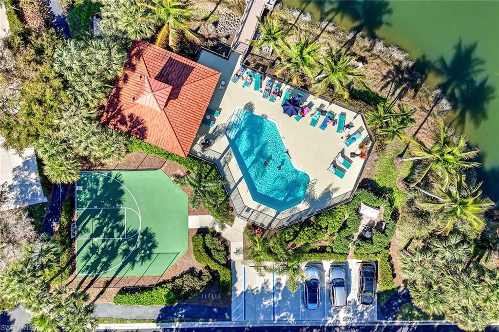 10921 Santa Margherita Road, Unit 103 Estero, FL 34135 - Photo 23 of 38 an aerial view of a house with a yard and large trees