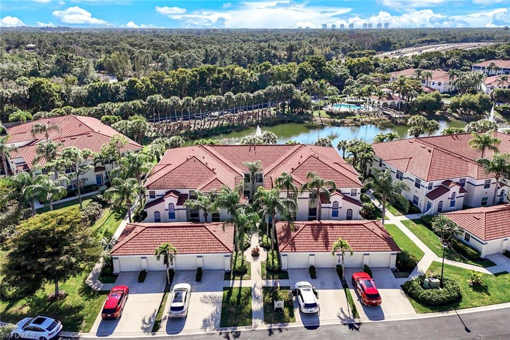 10921 Santa Margherita Road, Unit 103 Estero, FL 34135 - Photo 32 of 38 an aerial view of residential houses with outdoor space and parking