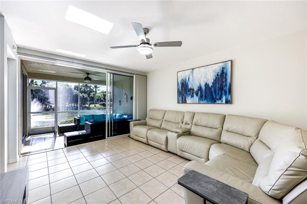 10921 Santa Margherita Road, Unit 103 Estero, FL 34135 - Photo 6 of 38 a living room with furniture and a large window