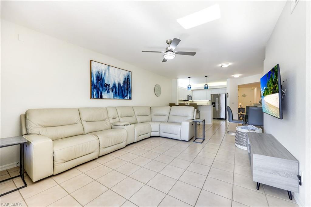 10921 Santa Margherita Road, Unit 103 Estero, FL 34135 - Photo 8 of 38 a living room with furniture and a flat screen tv