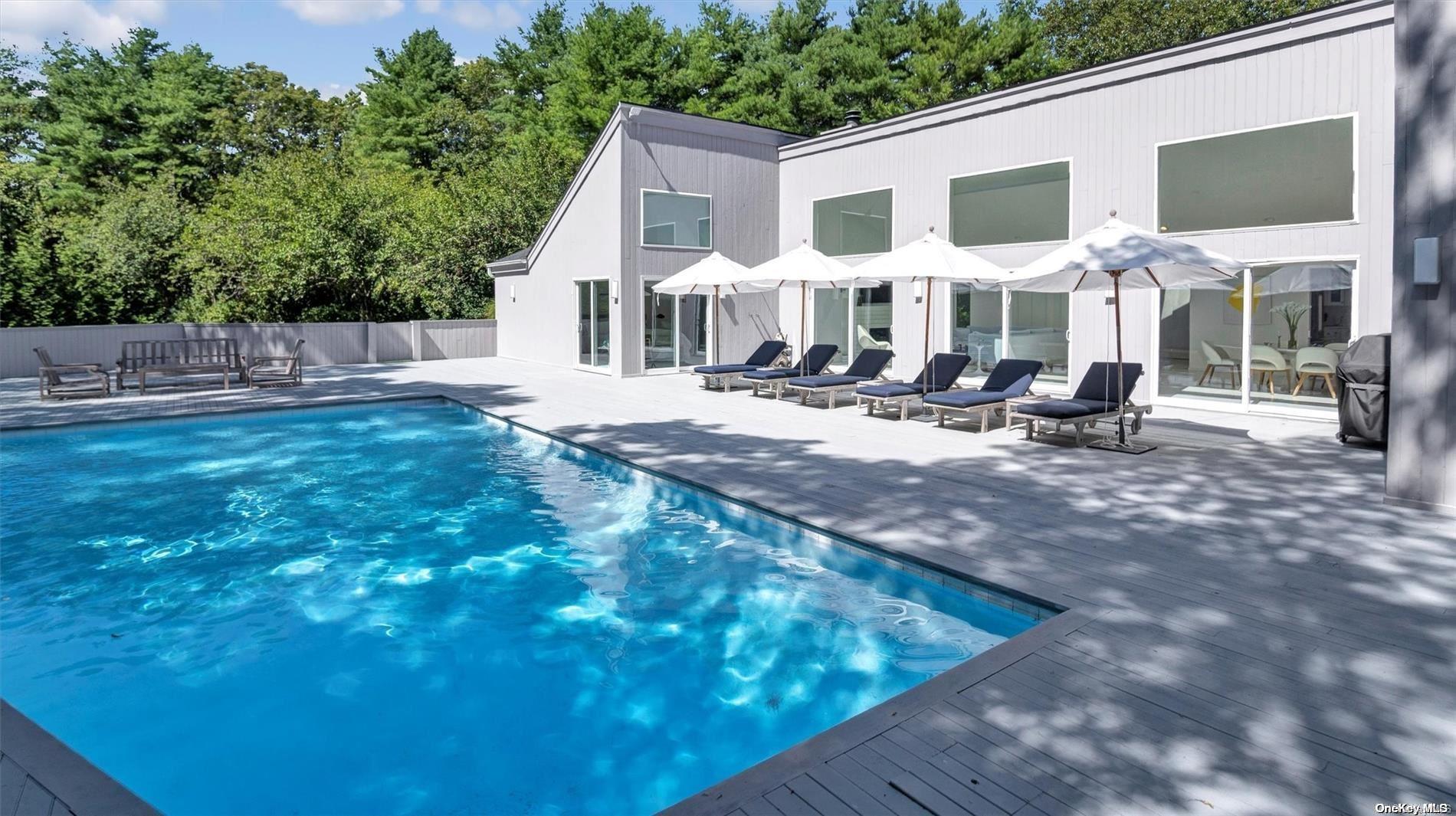a view of a house with backyard porch and sitting area