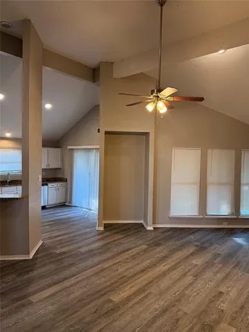 a view of a livingroom with a ceiling fan and hardwood floor