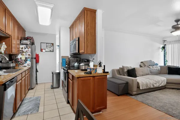 a kitchen with stainless steel appliances granite countertop a stove a sink and a refrigerator