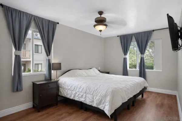 a bedroom with a large bed and a large window