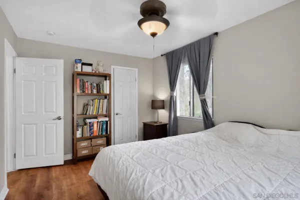 a bedroom with a bed and a book shelf