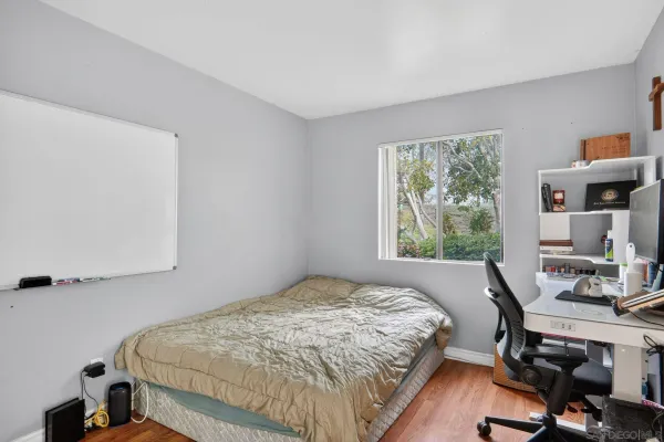 a bedroom with a bed and a desk