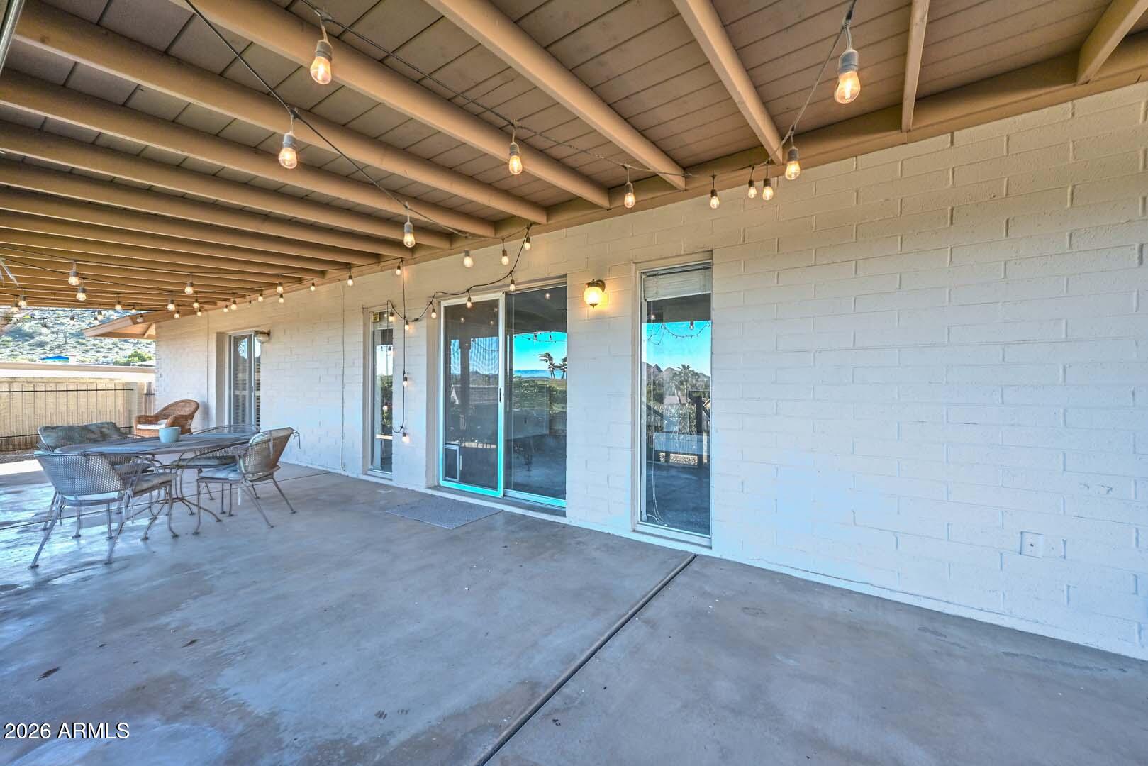 13013 North Surrey Circle Phoenix, AZ 85029 - Photo 34 of 36 a view of a porch with chairs and floor to ceiling window