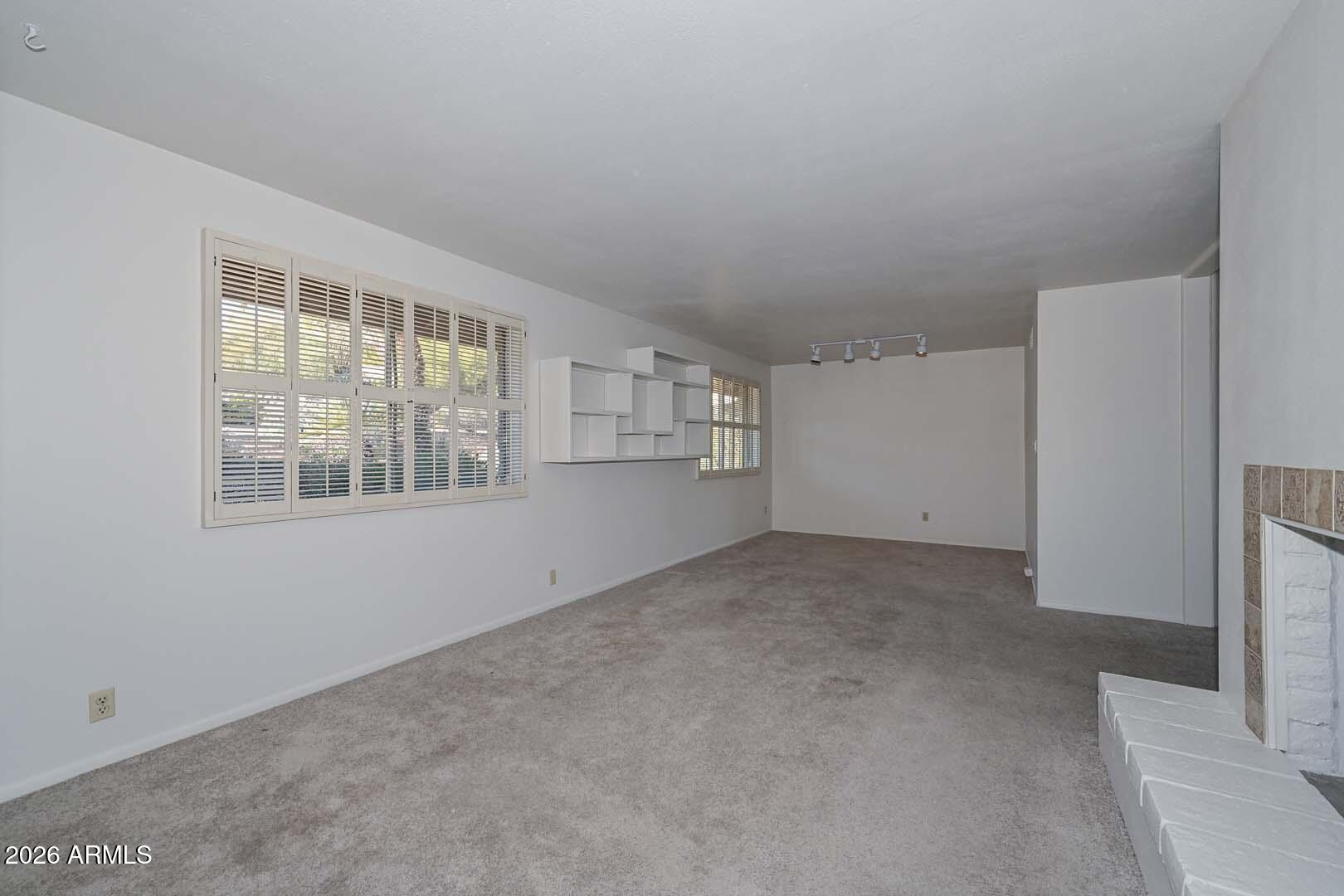 13013 North Surrey Circle Phoenix, AZ 85029 - Photo 5 of 36 an empty room with windows