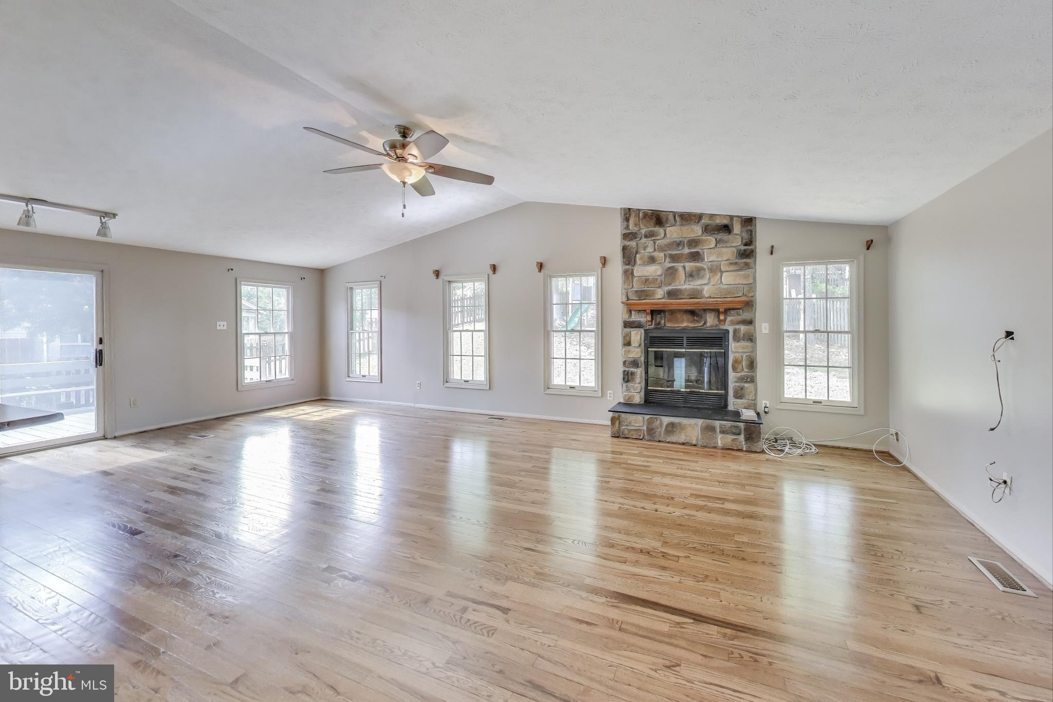 9217 Briarchip Street Laurel, MD 20708 - Photo 13 of 45 a view of an empty room with wooden floor and a window