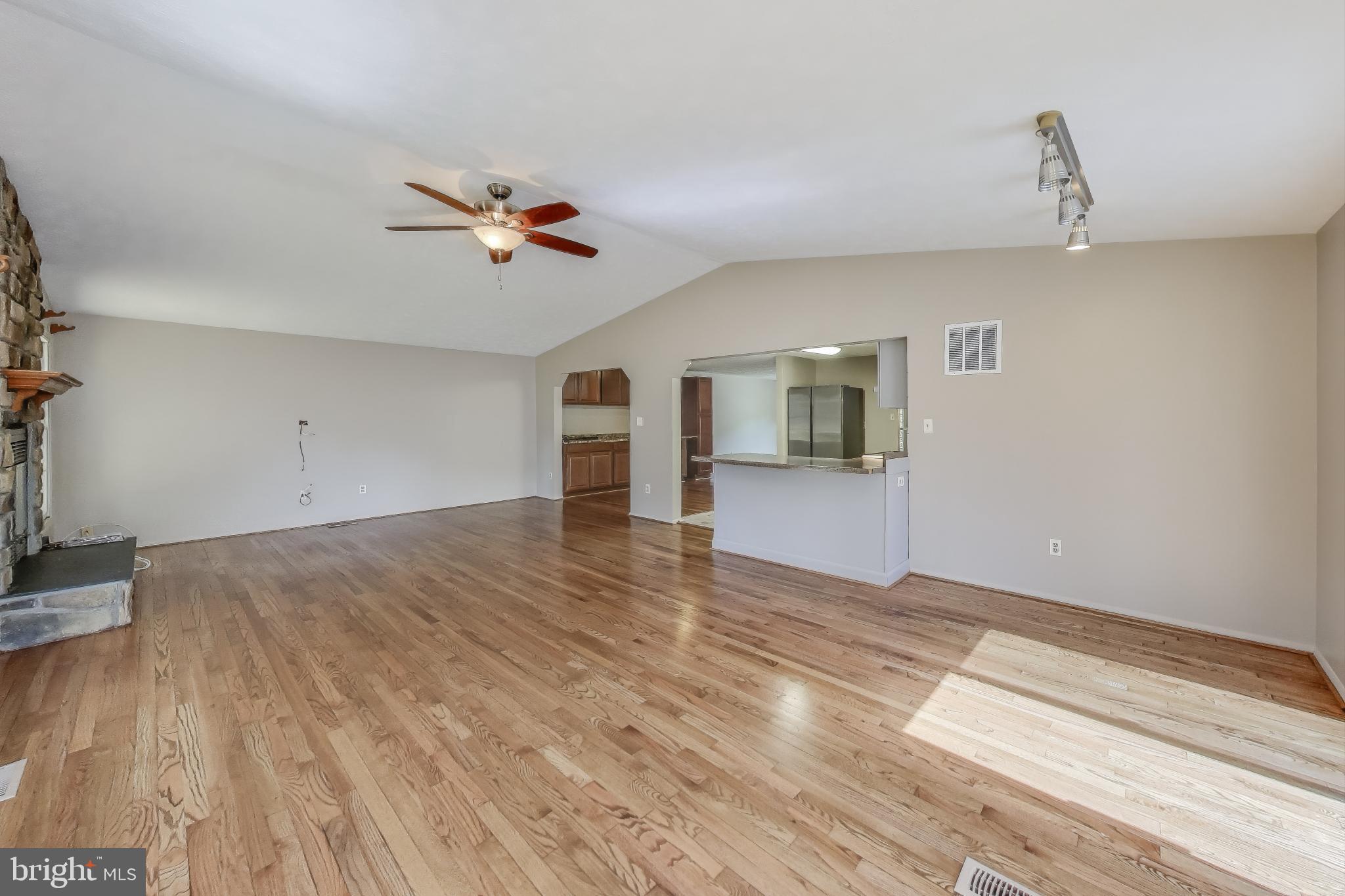 9217 Briarchip Street Laurel, MD 20708 - Photo 15 of 45 a view of a kitchen with wooden floor and a ceiling fan