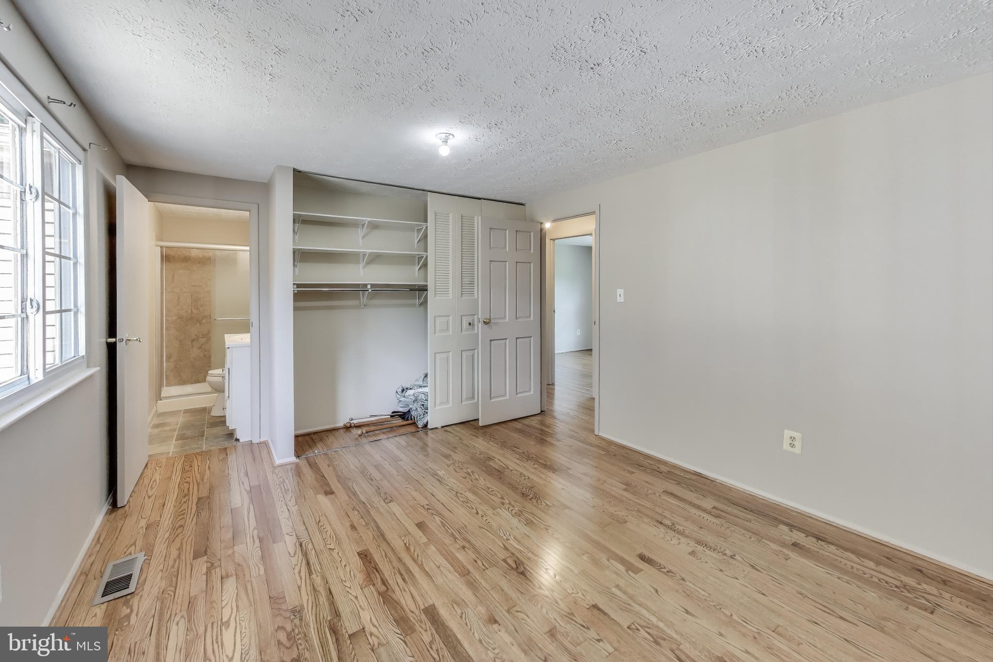 9217 Briarchip Street Laurel, MD 20708 - Photo 18 of 45 a view of an empty room with a window and wooden floor
