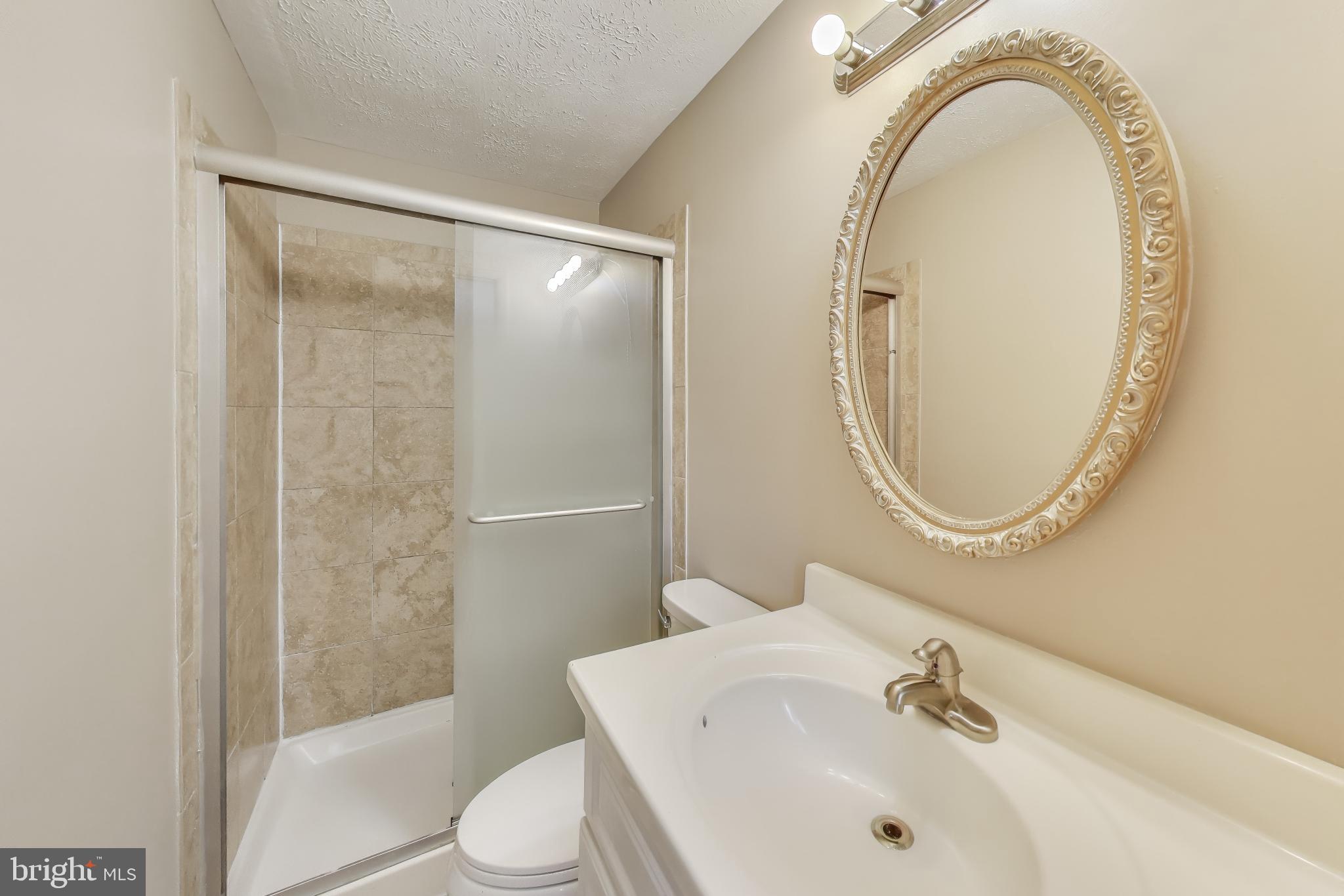 9217 Briarchip Street Laurel, MD 20708 - Photo 19 of 45 a bathroom with a sink and a mirror