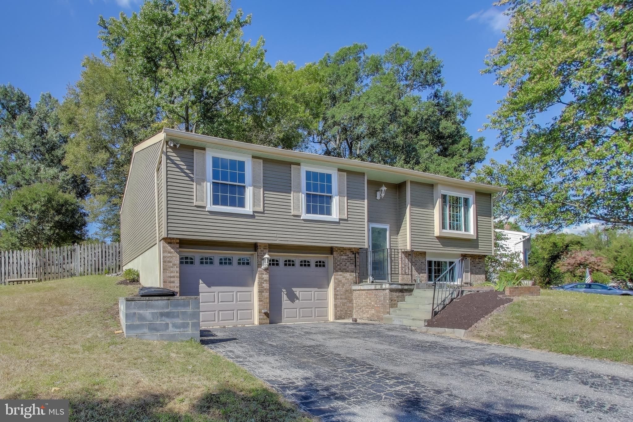 9217 Briarchip Street Laurel, MD 20708 - Photo 2 of 45 a front view of a house with a yard and garage