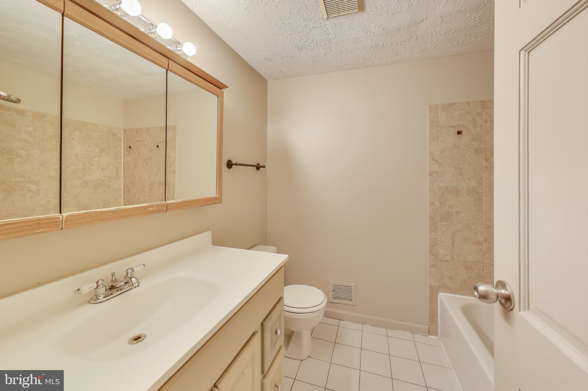 9217 Briarchip Street Laurel, MD 20708 - Photo 24 of 45 a bathroom with a sink a toilet and shower
