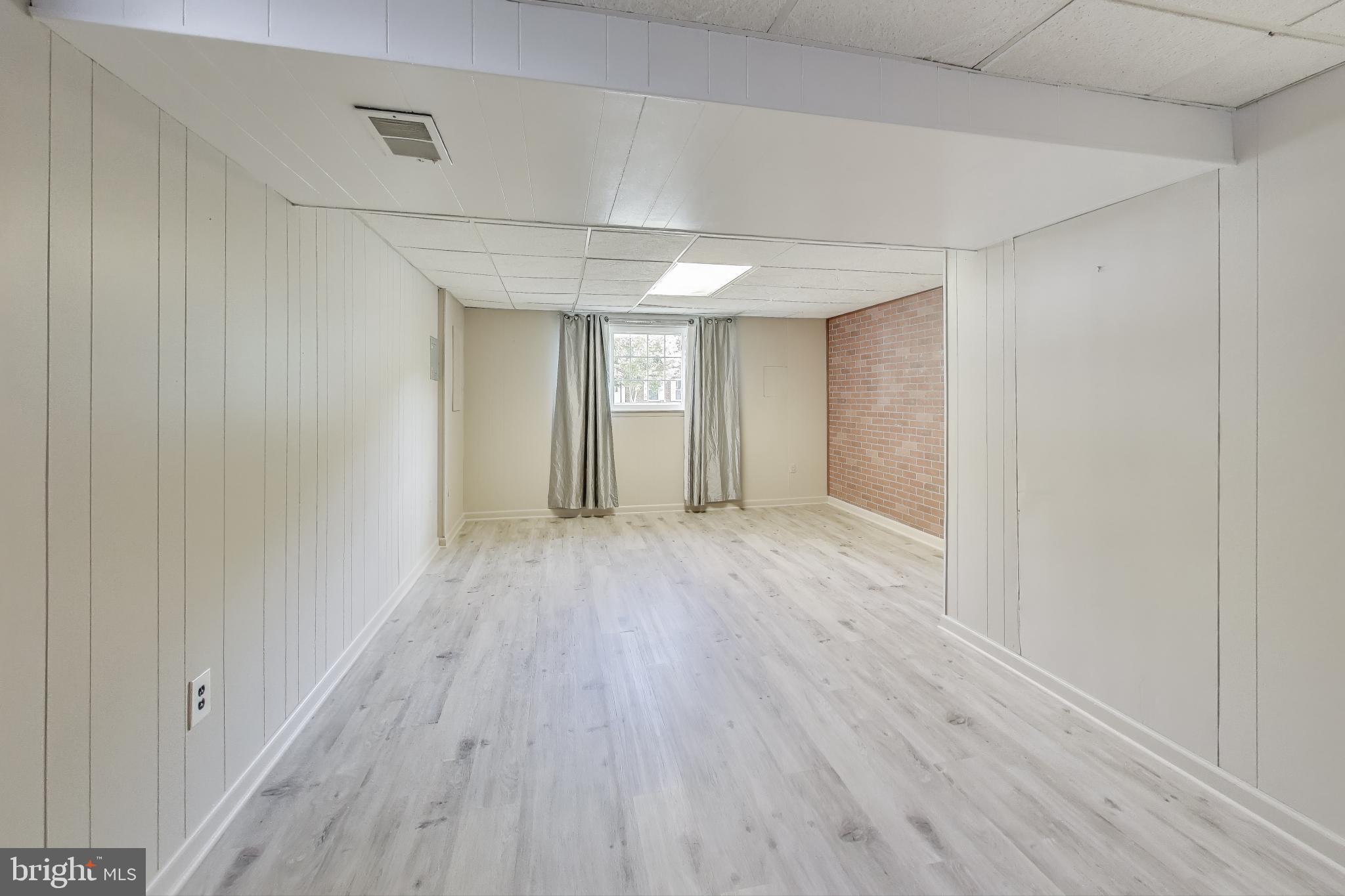 9217 Briarchip Street Laurel, MD 20708 - Photo 26 of 45 a view of an empty room with wooden floor
