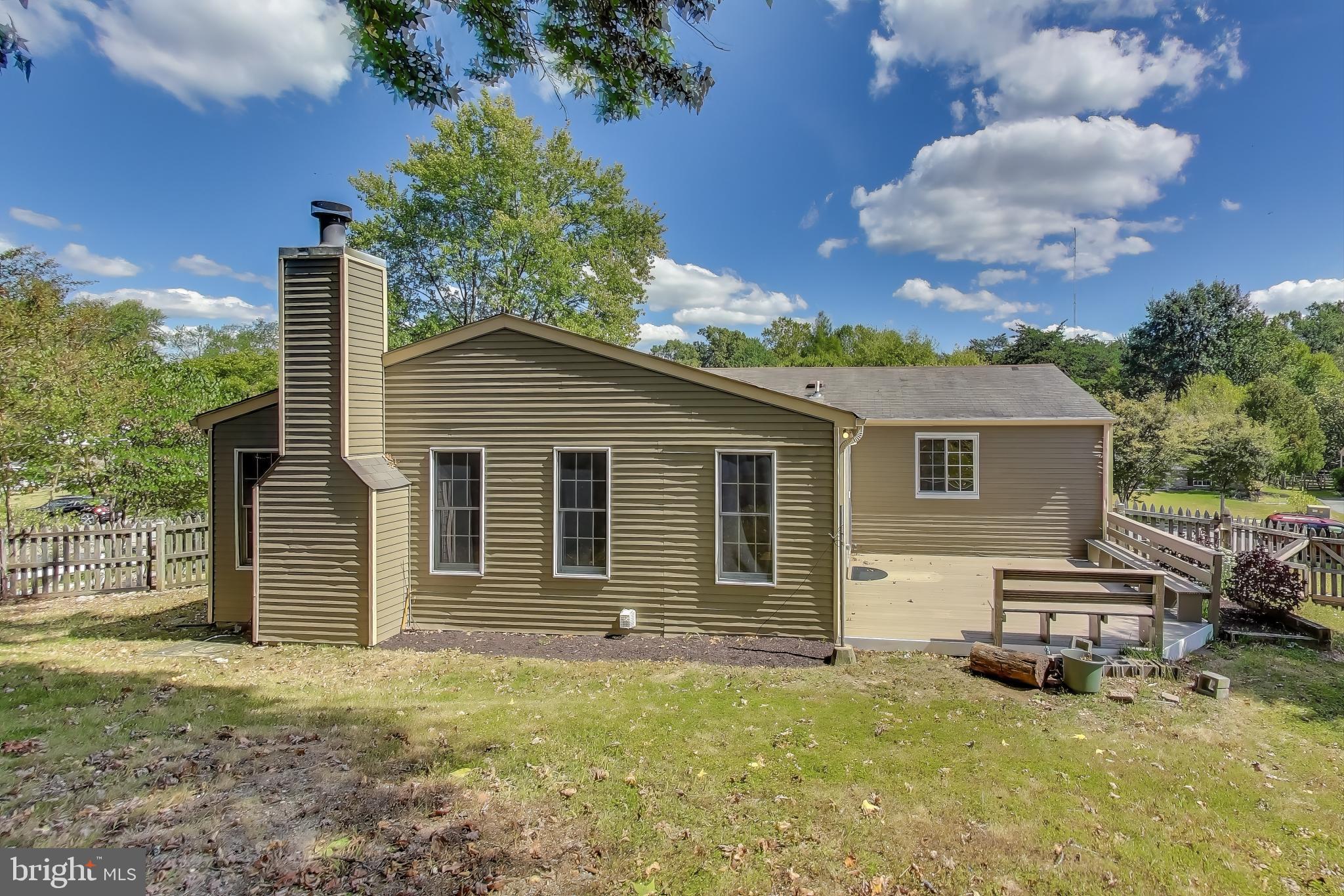 9217 Briarchip Street Laurel, MD 20708 - Photo 35 of 45 a backyard of a house with yard and outdoor seating