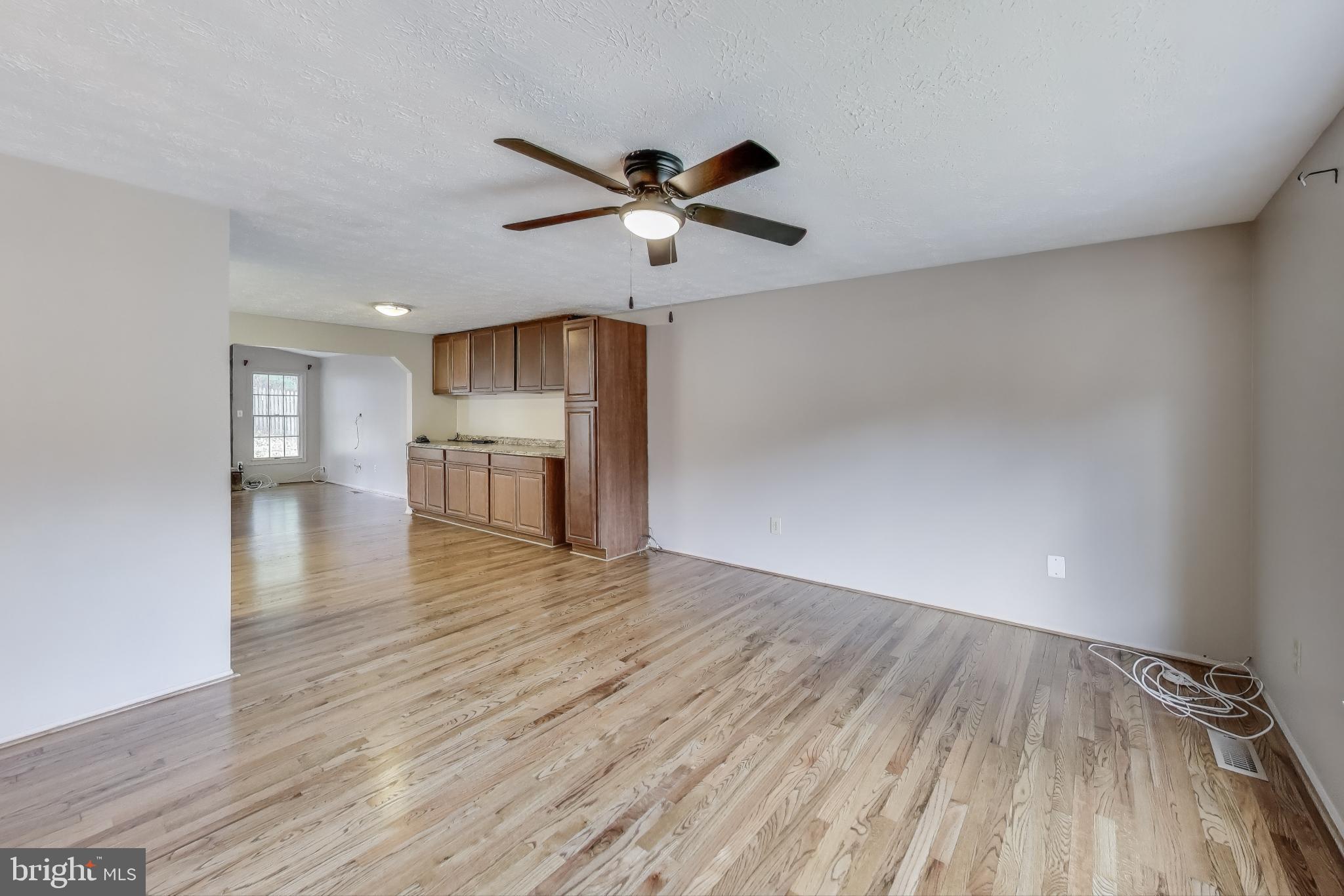 9217 Briarchip Street Laurel, MD 20708 - Photo 7 of 45 a view of empty room with wooden floor and fan