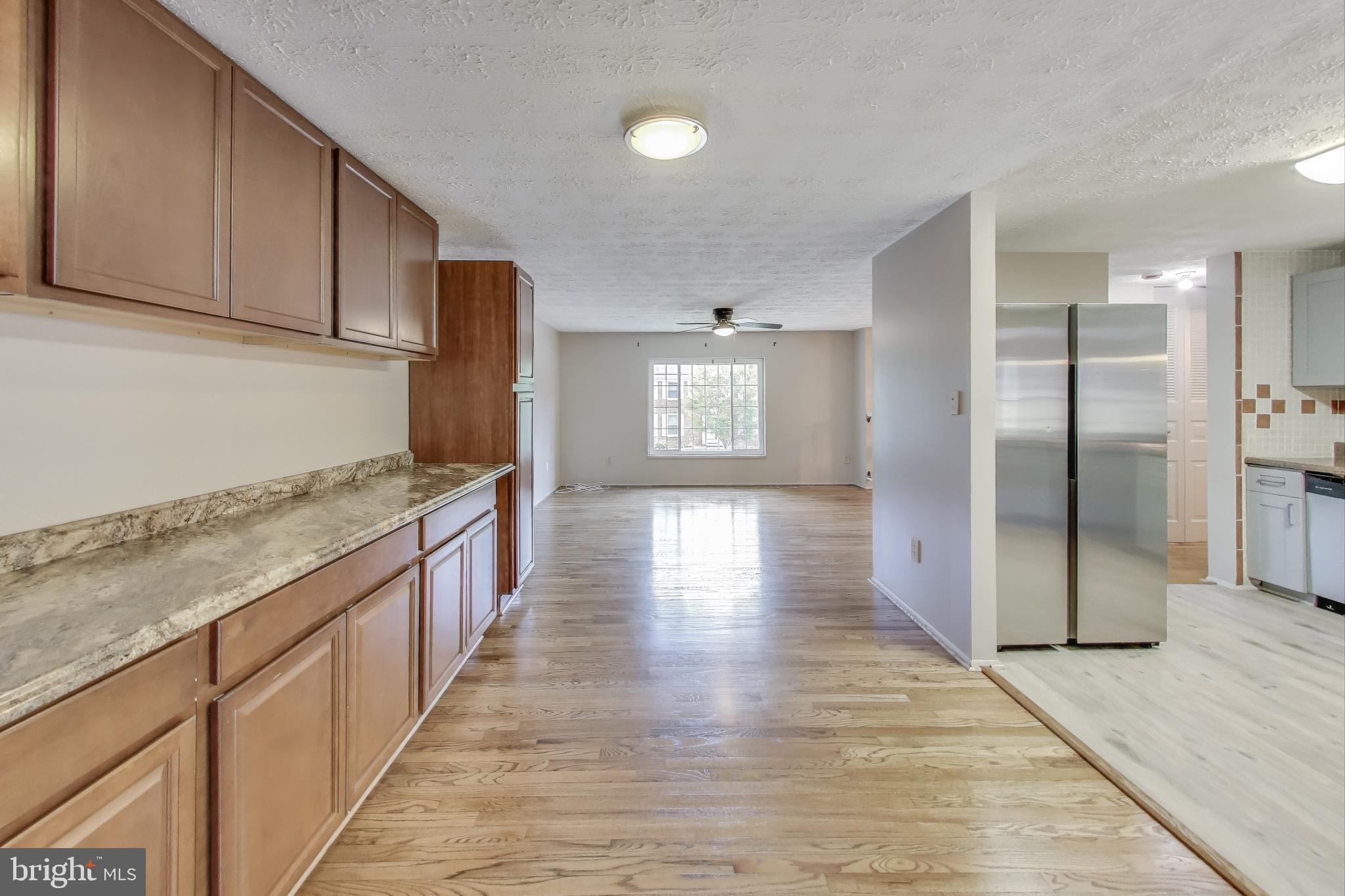 9217 Briarchip Street Laurel, MD 20708 - Photo 8 of 45 a kitchen with stainless steel appliances granite countertop a refrigerator and a sink