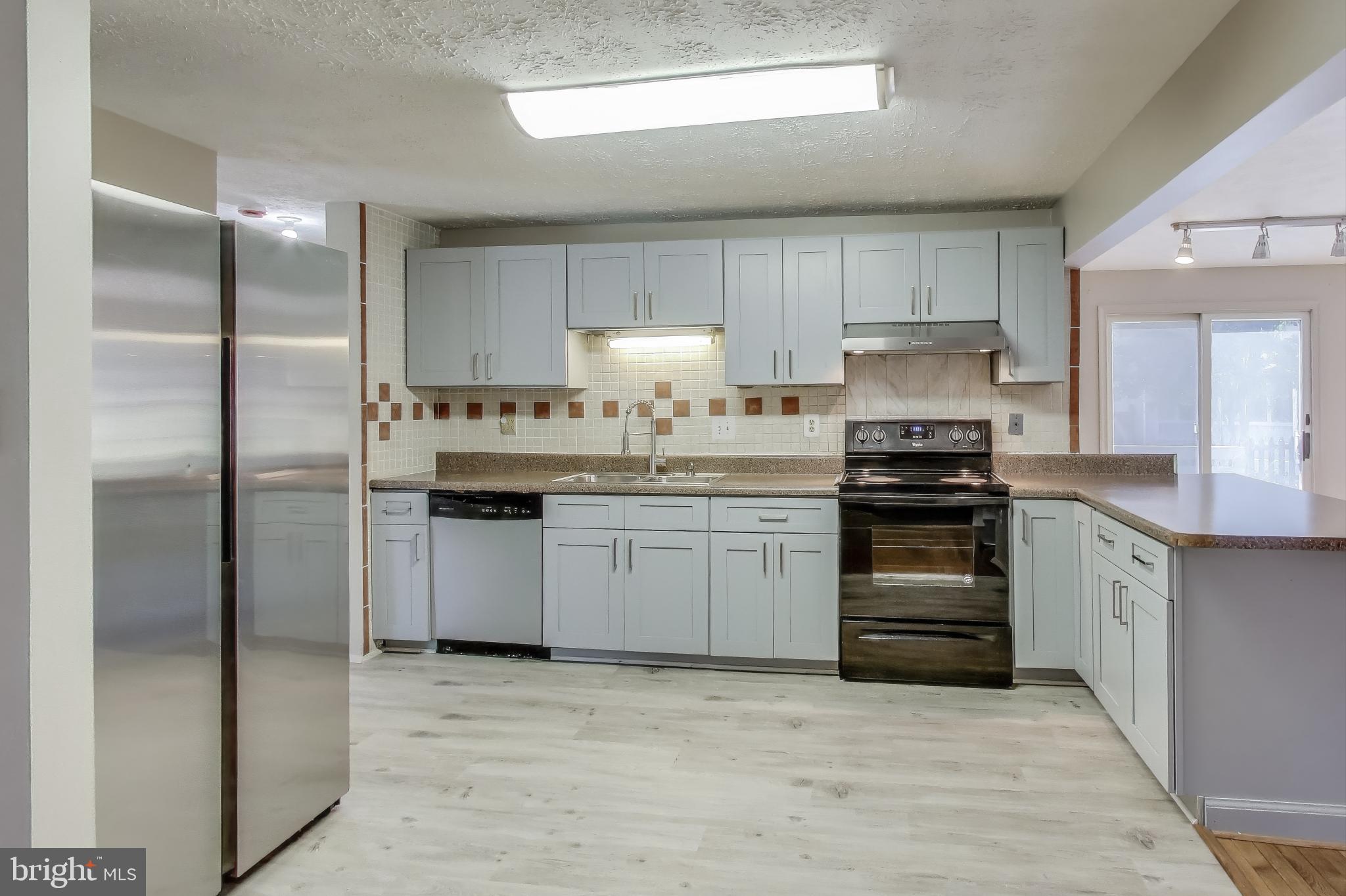 9217 Briarchip Street Laurel, MD 20708 - Photo 10 of 45 a kitchen with a sink cabinets stainless steel appliances and a window