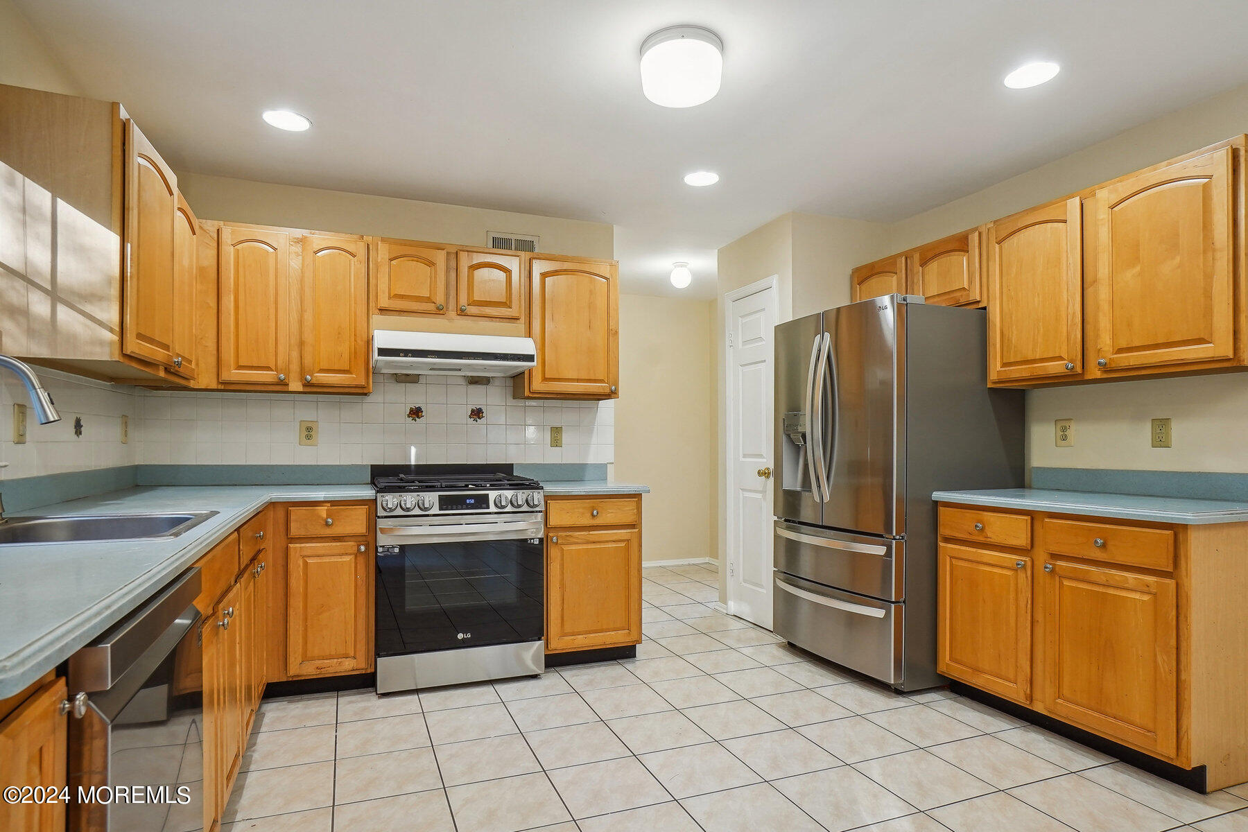 2 Stratton Road Matawan, NJ 07747 - Photo 13 of 34 a kitchen with stainless steel appliances granite countertop a stove top oven a refrigerator and cabinets