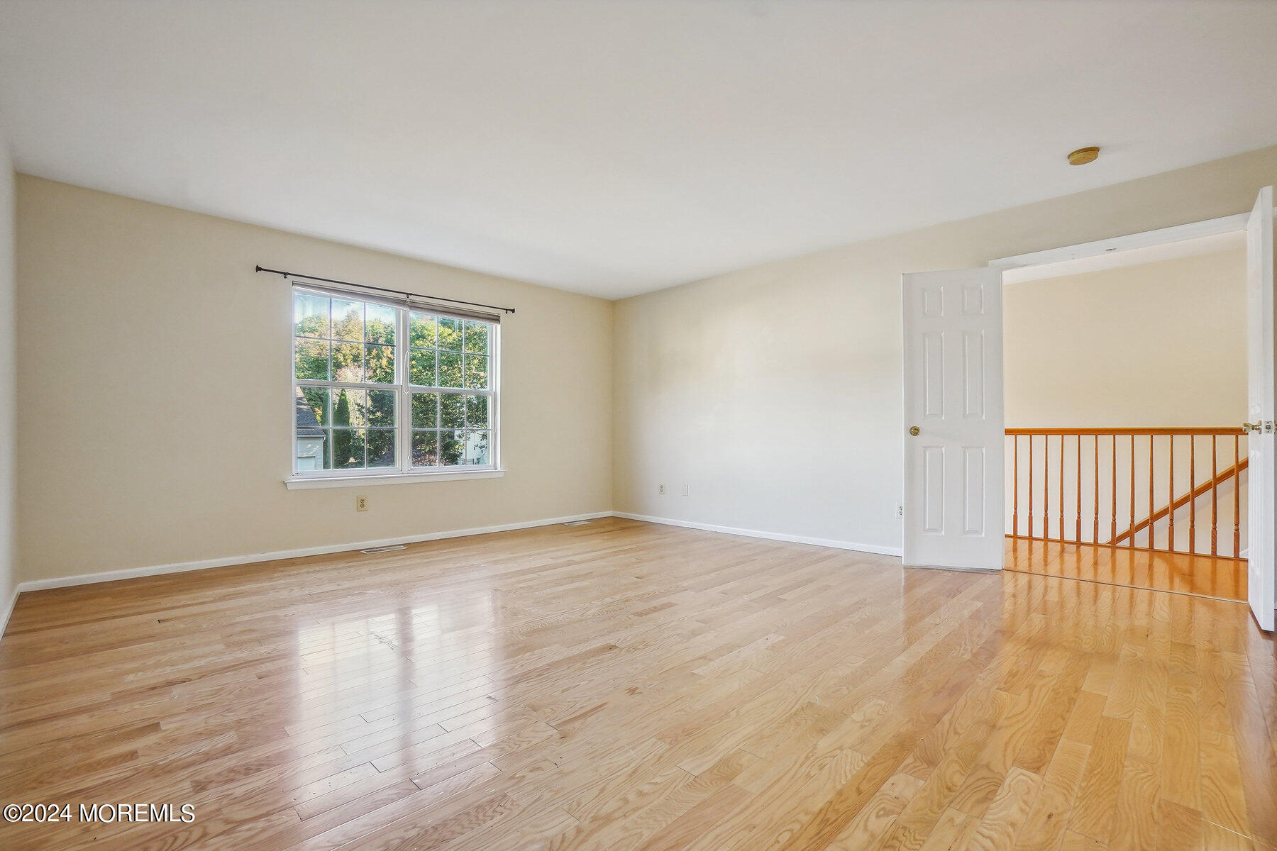 2 Stratton Road Matawan, NJ 07747 - Photo 18 of 34 a view of an empty room with wooden floor and a window